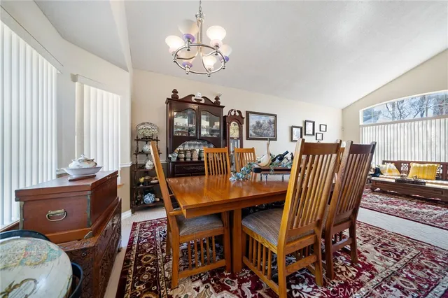 a dining room with furniture a rug and a chandelier