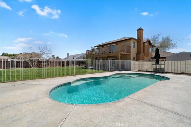 a view of a swimming pool with a backyard