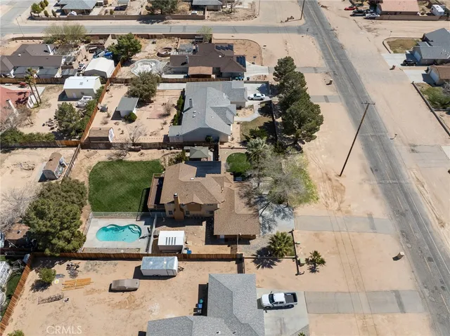 an aerial view of a house with a yard