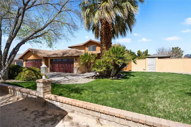 a front view of a house with a yard and a garage