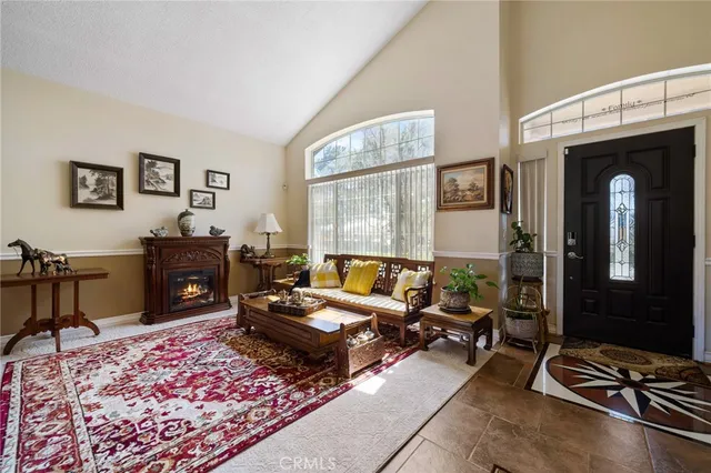 a living room with furniture a rug and a window