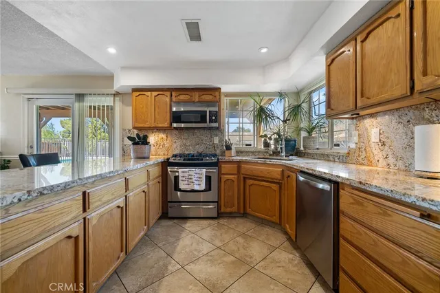 a kitchen with stainless steel appliances granite countertop a sink and cabinets