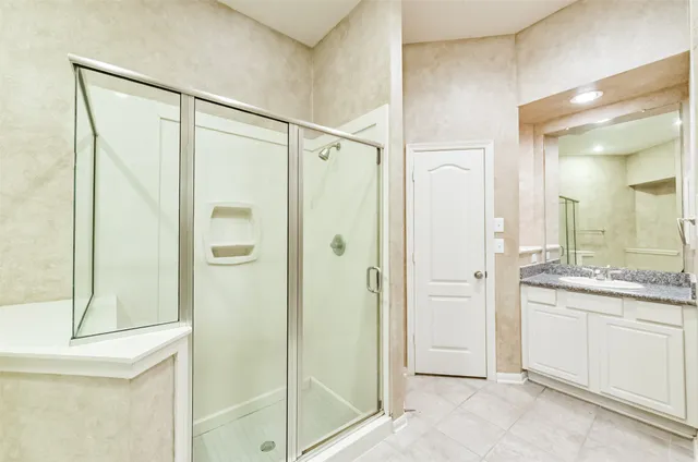 a bathroom with a shower and a sink