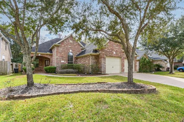 a house with a large trees in front of it