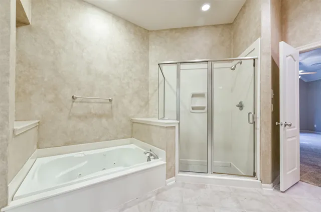 a bathroom with a bathtub and a shower