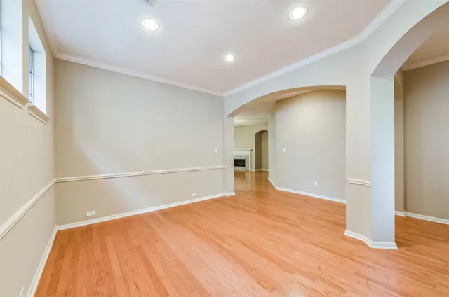 a view of empty room with wooden floor