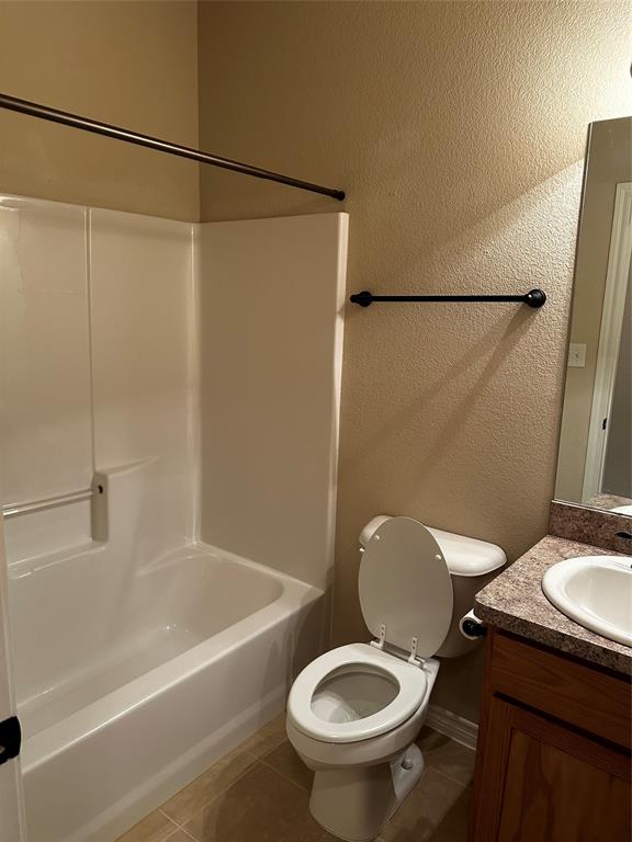 1908 Elizabeth Street Sherman, TX 75090 - Photo 13 of 17 a bathroom with a sink a toilet and a bathtub