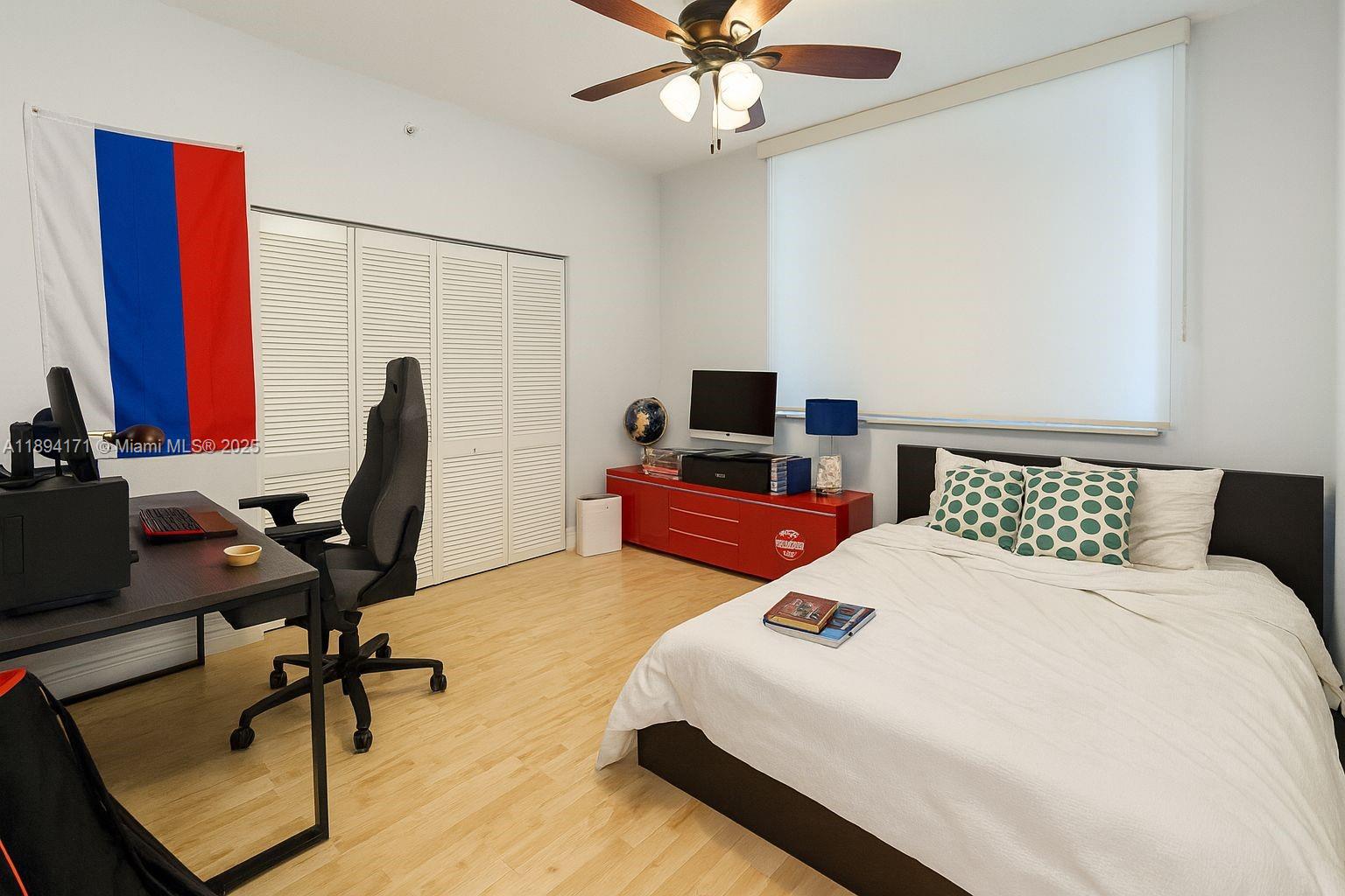 31 Southeast 5th Street, Unit 4016 Miami, FL 33131 - Photo 11 of 14 a bedroom with a bed a desk and chair