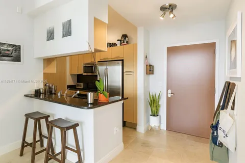 a kitchen with stainless steel appliances granite countertop a refrigerator and a stove