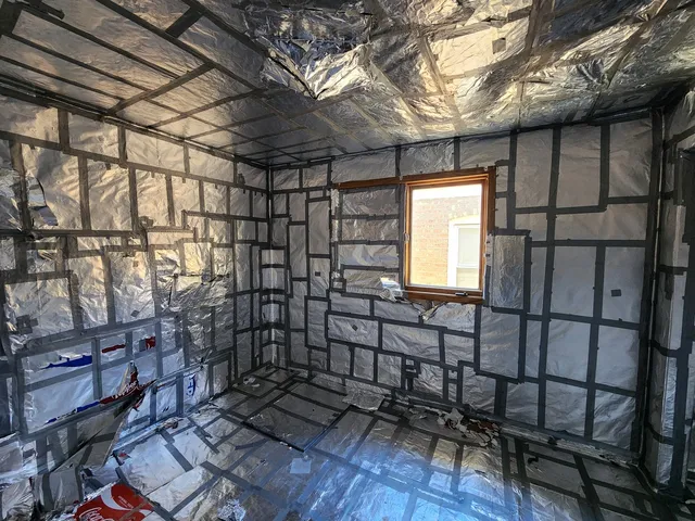 a view of a room with wooden floor and a window