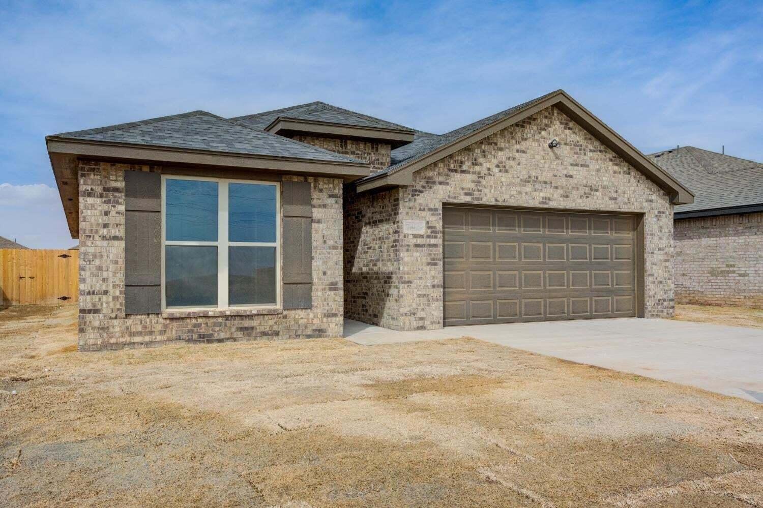 7808 97th Street Lubbock, TX 79424 - Photo 1 of 38 a front view of a house with a yard and garage