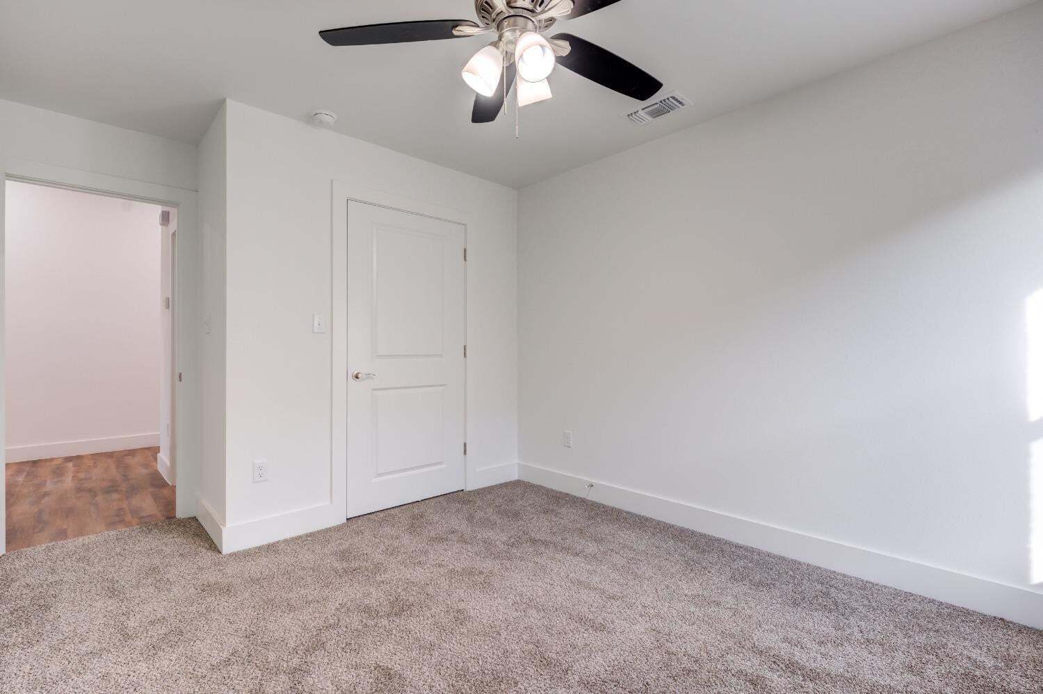 7808 97th Street Lubbock, TX 79424 - Photo 12 of 38 an empty room with chandelier fan