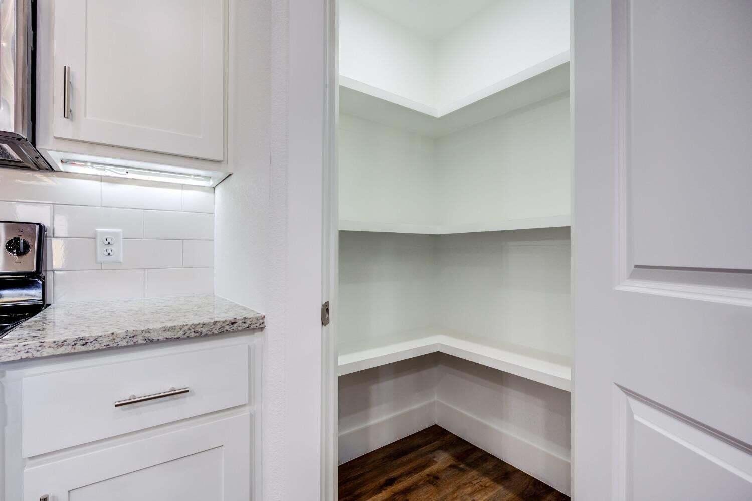 7808 97th Street Lubbock, TX 79424 - Photo 13 of 38 a storage room with wooden floor