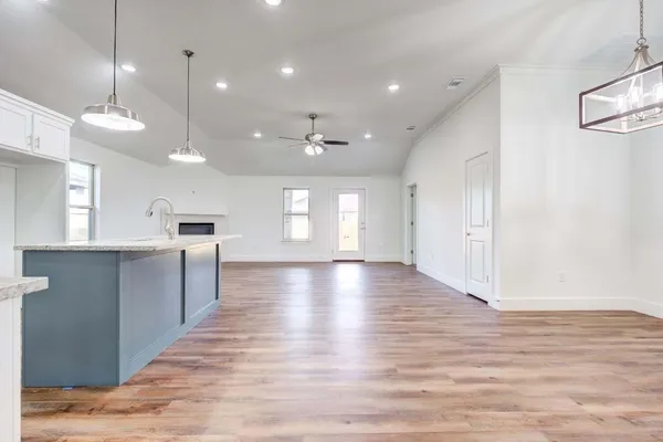 a view of a kitchen with a sink and a large window