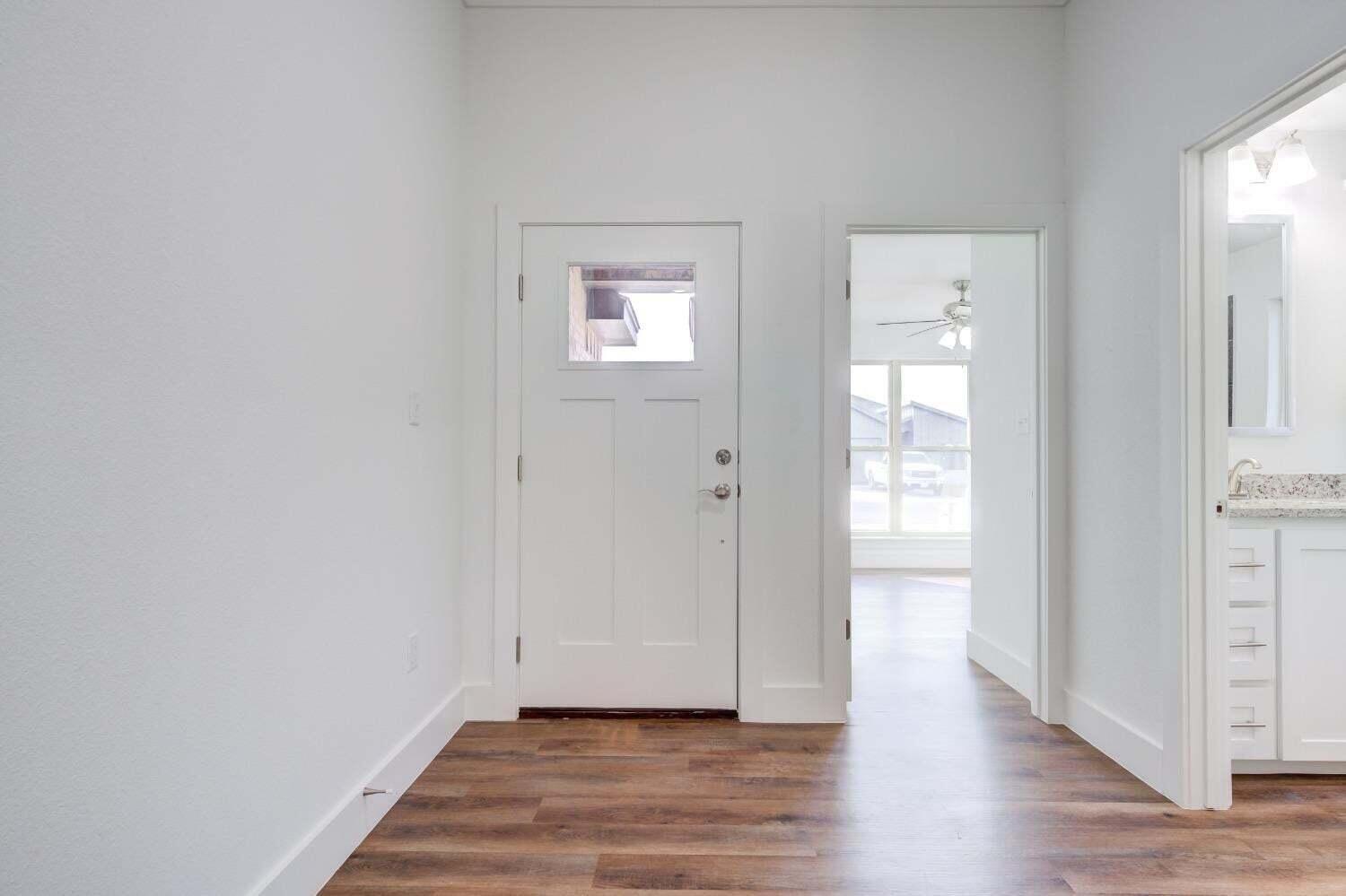7808 97th Street Lubbock, TX 79424 - Photo 2 of 38 a view of an empty room and wooden floor