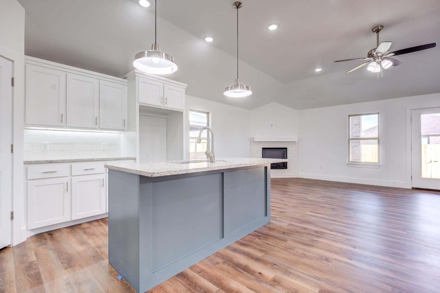 7808 97th Street Lubbock, TX 79424 - Photo 23 of 38 a kitchen with kitchen island a window and stainless steel appliances