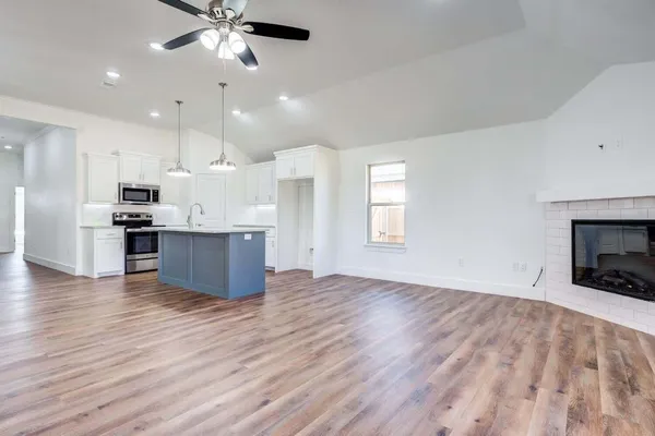 a view of kitchen with sink and wooden floor