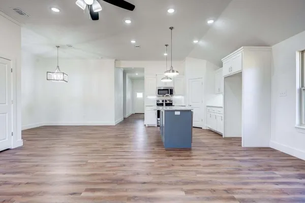 a view of kitchen and kitchen with a refrigerator