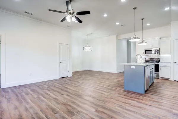 a view of kitchen and kitchen with wooden floor