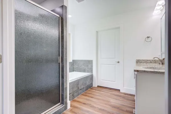 a bathroom with a bathtub and a shower