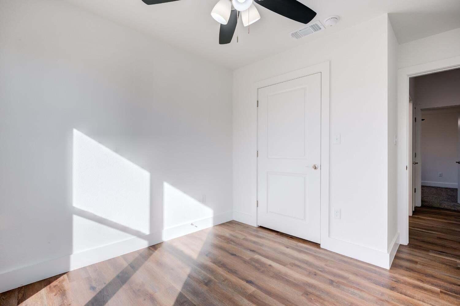 7808 97th Street Lubbock, TX 79424 - Photo 4 of 38 a view of an empty room with wooden floor