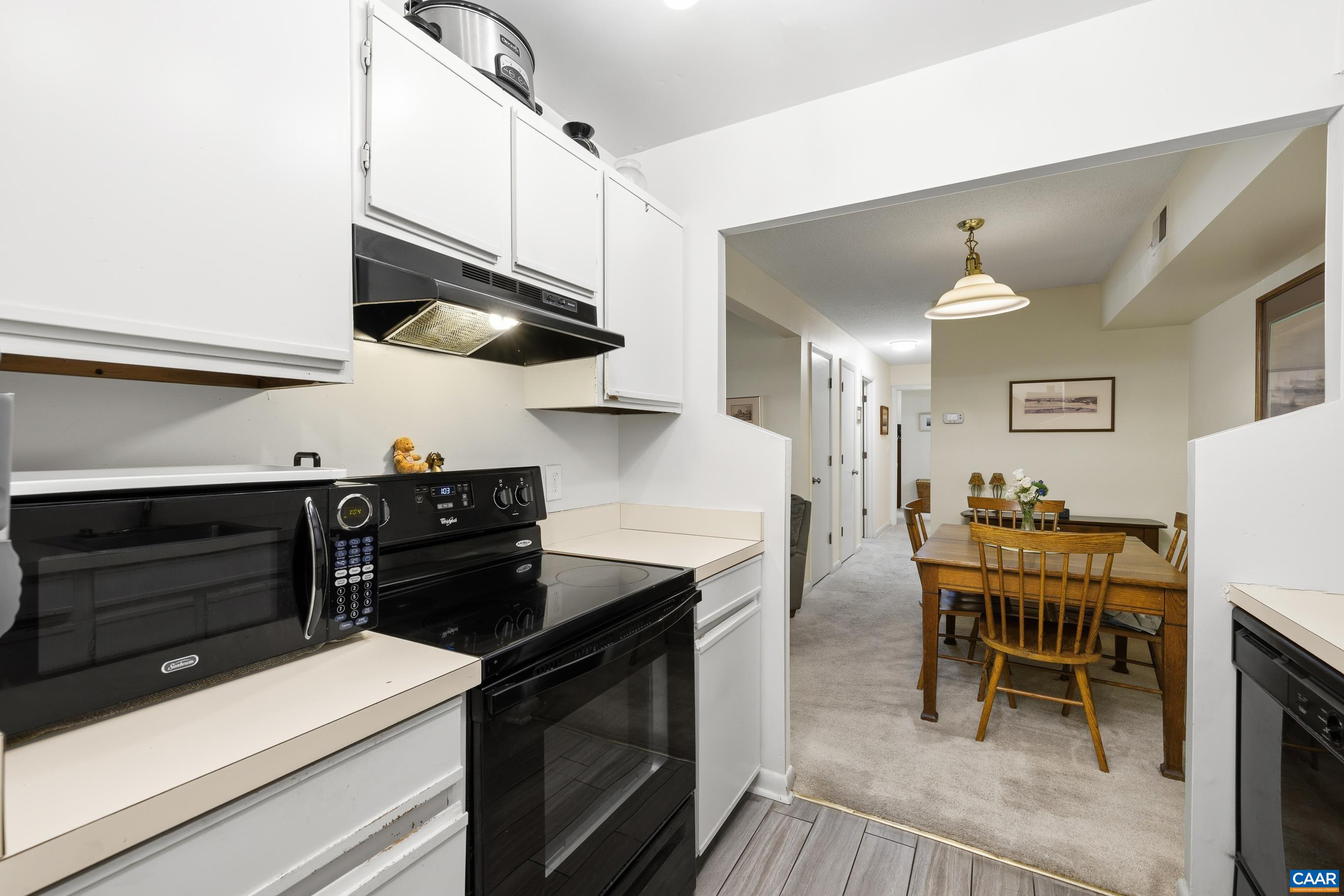 103 Turtle Creek Road, Unit 1 Charlottesville, VA 22901 - Photo 16 of 24 a kitchen with stainless steel appliances kitchen island a table and chairs in it