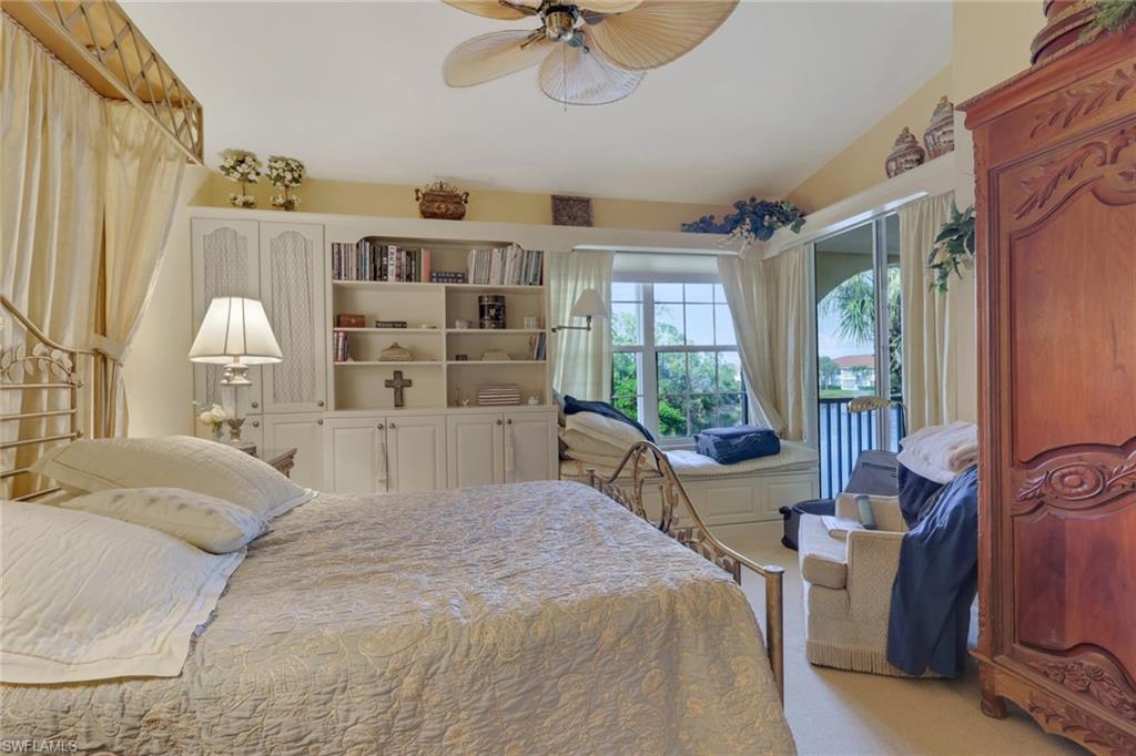10801 Crooked River Road, Unit 203 Estero, FL 34135 - Photo 21 of 27 a large bedroom with a large bed and a window