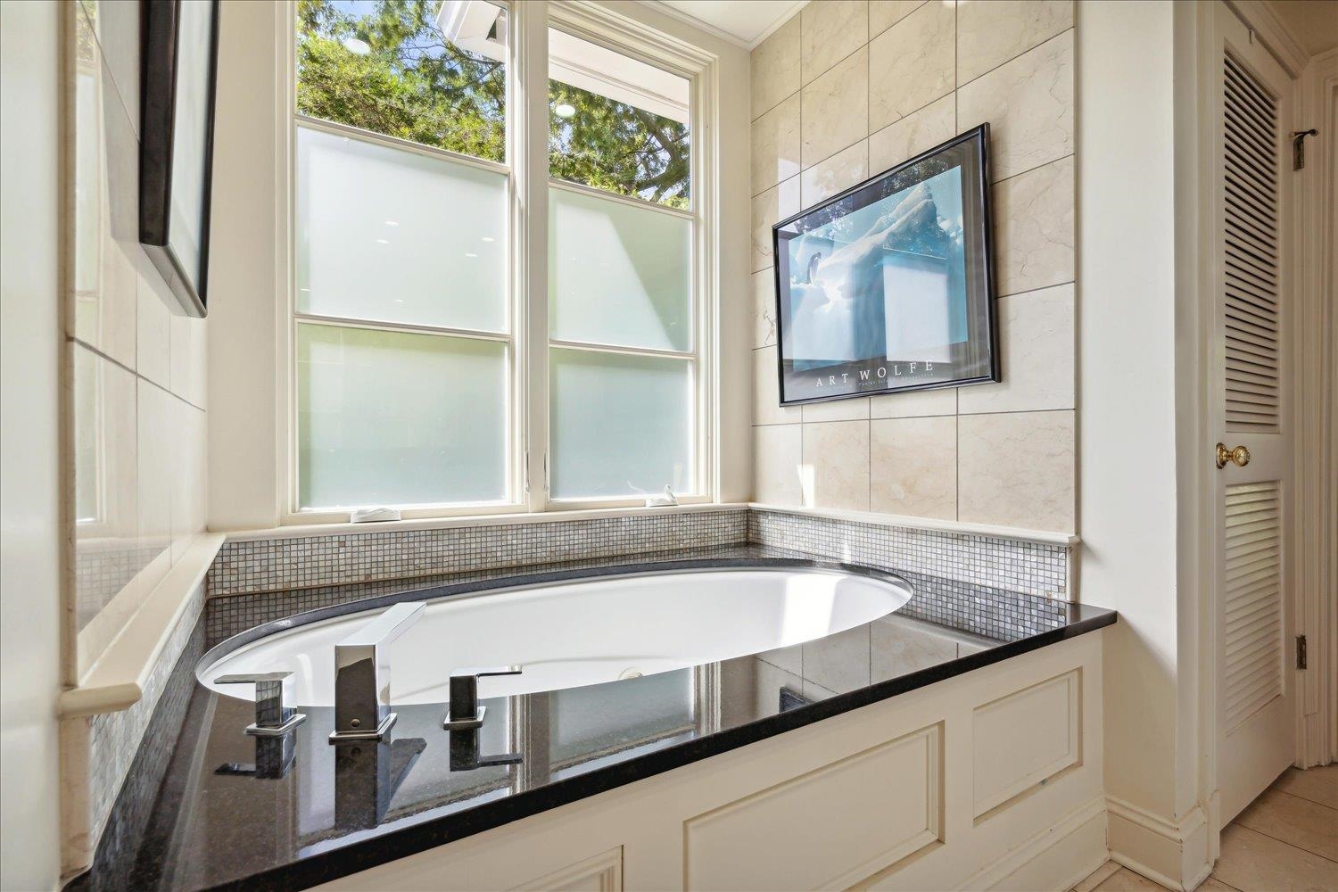 24 South Rose Road Memphis, TN 38117 - Photo 23 of 40 a bathroom with a granite countertop sink and mirror