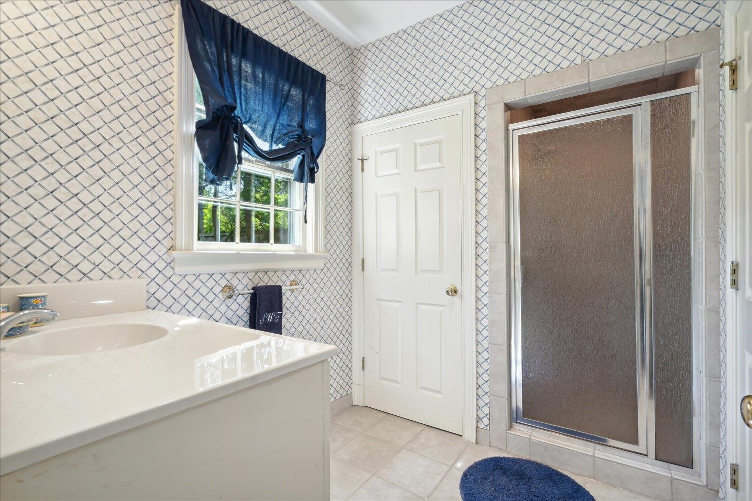 24 South Rose Road Memphis, TN 38117 - Photo 27 of 40 a bathroom with a sink a toilet and a window