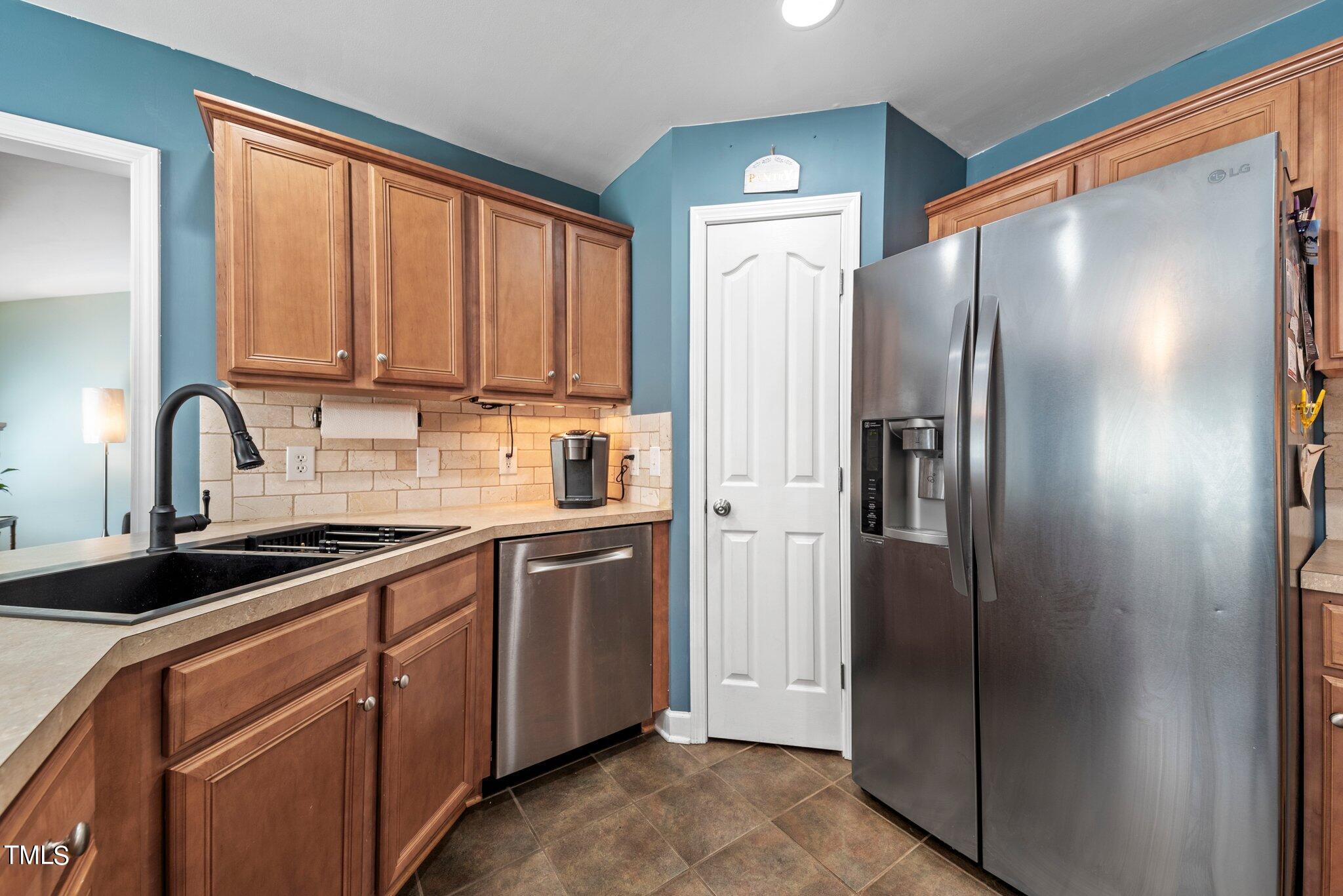 2461 Farrell Road Mebane, NC 27302 - Photo 11 of 35 a kitchen with stainless steel appliances granite countertop a refrigerator and a sink