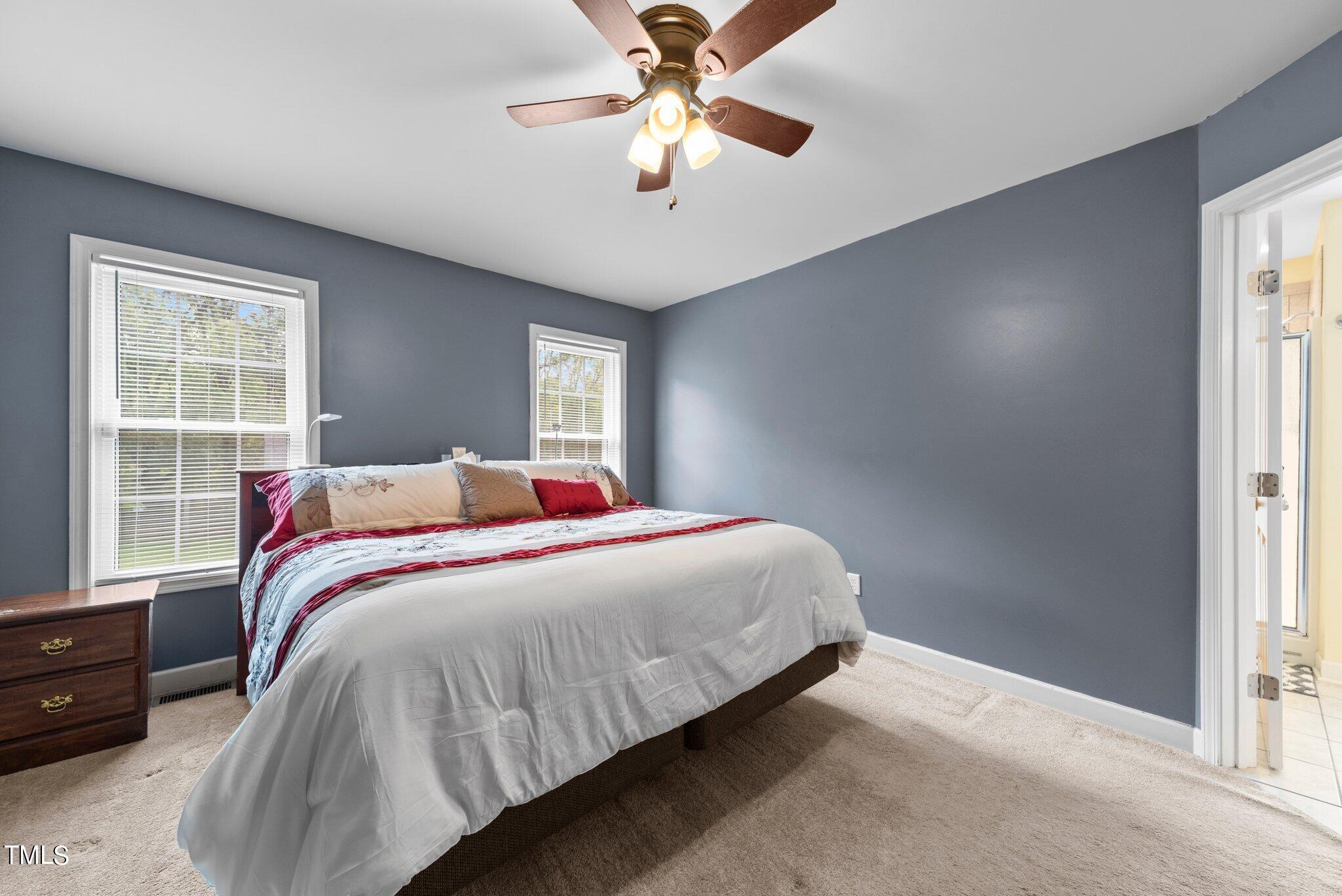 2461 Farrell Road Mebane, NC 27302 - Photo 12 of 35 a bedroom with a bed and a chandelier