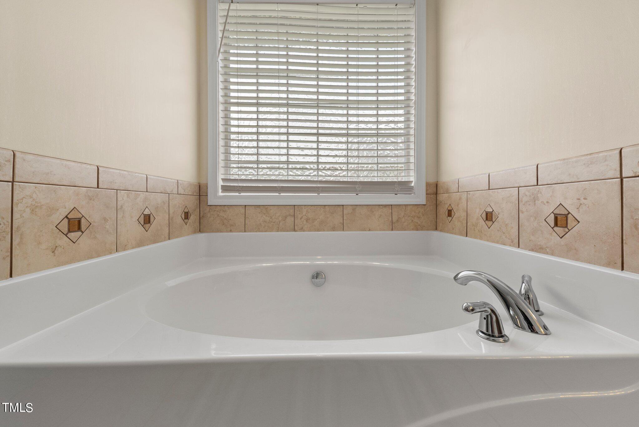 2461 Farrell Road Mebane, NC 27302 - Photo 15 of 35 a white bath tub sitting next to a window