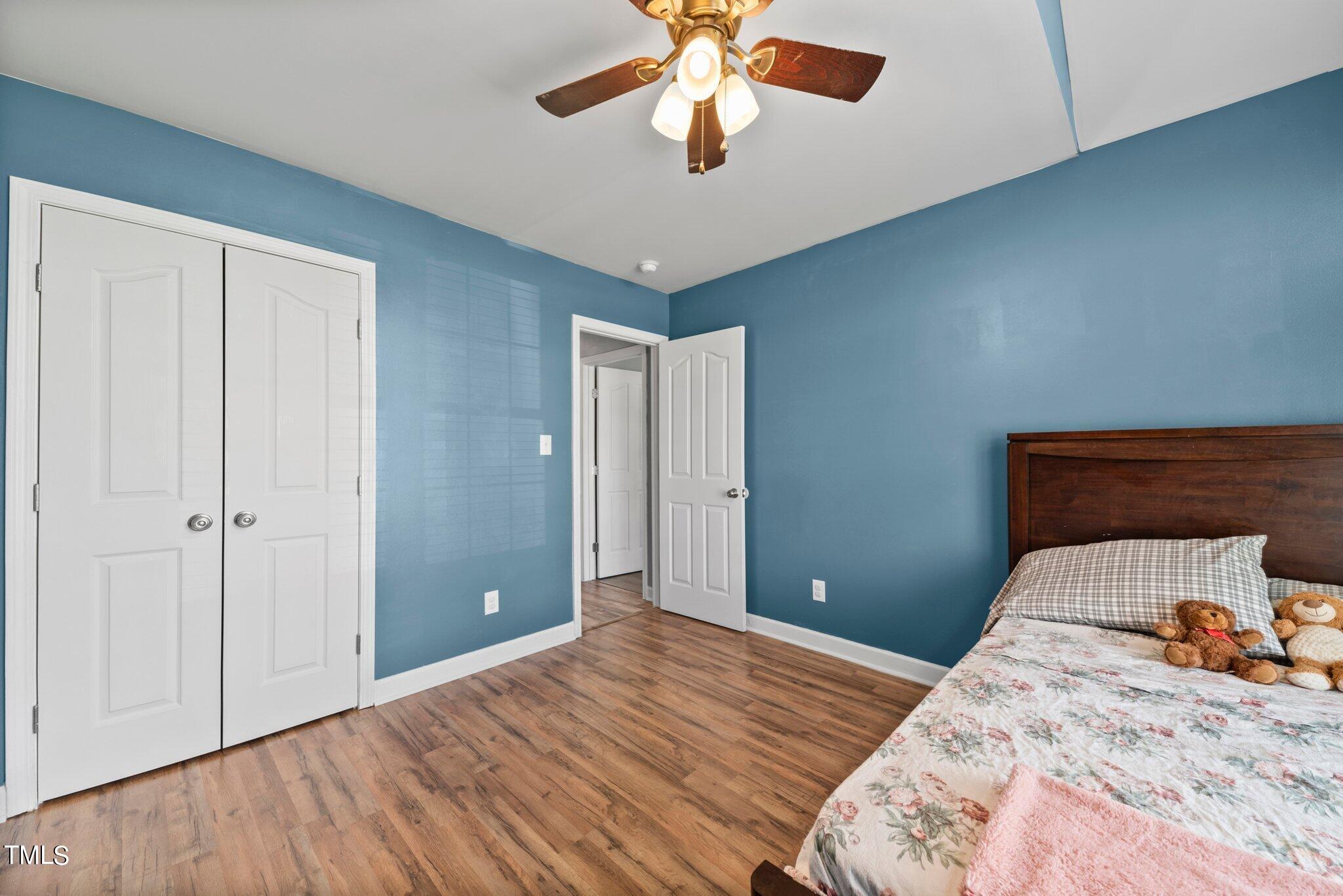 2461 Farrell Road Mebane, NC 27302 - Photo 19 of 35 a bedroom with a bed and a chandelier