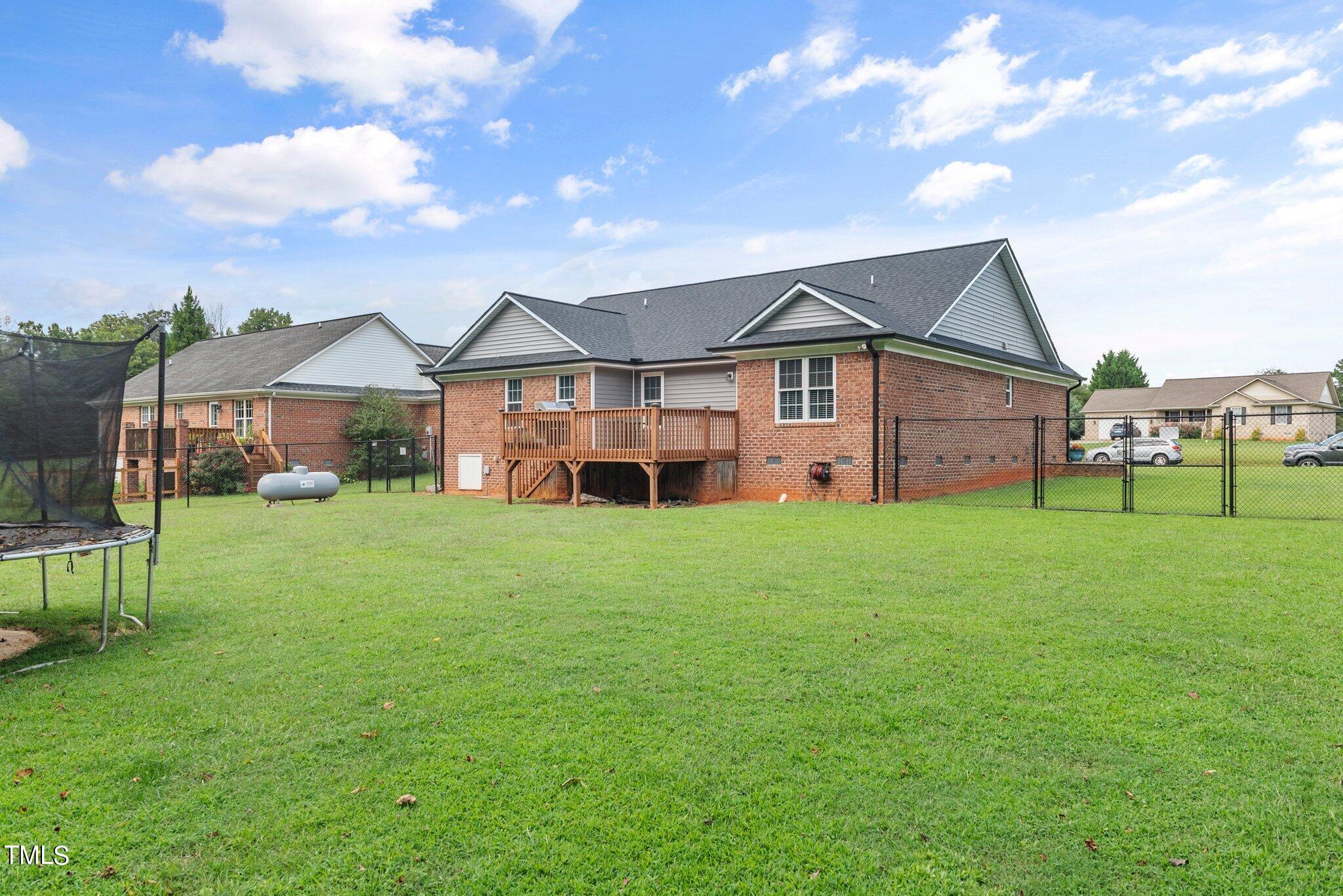 2461 Farrell Road Mebane, NC 27302 - Photo 24 of 35 a yellow and red house sitting in middle of the grass