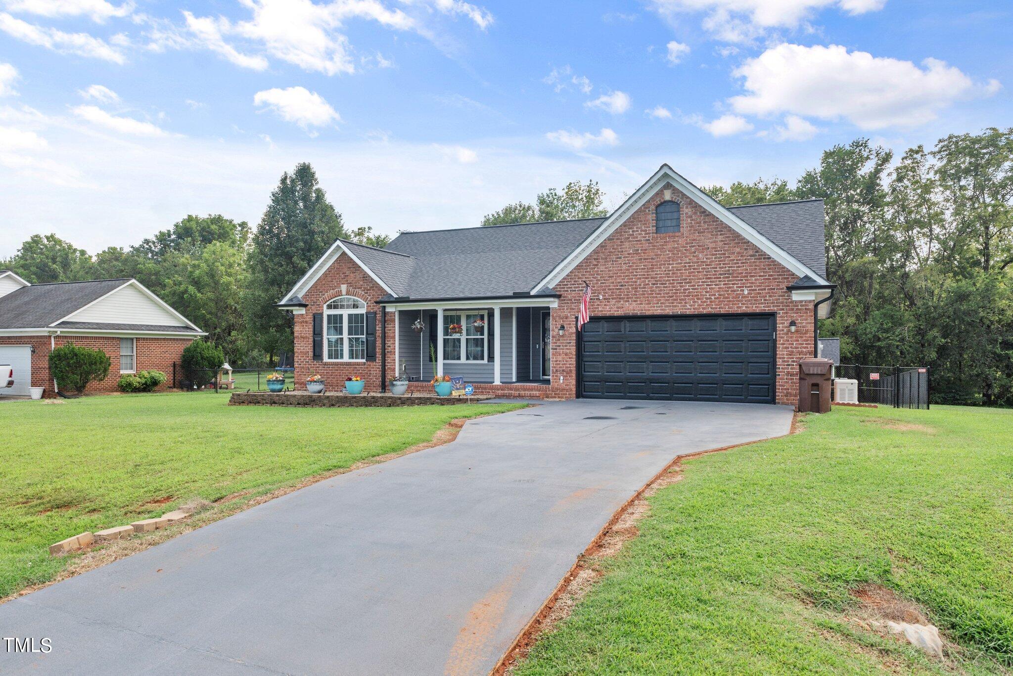 2461 Farrell Road Mebane, NC 27302 - Photo 29 of 35 a front view of a house with a yard and garage