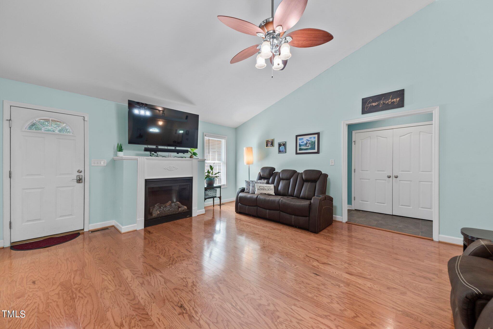 2461 Farrell Road Mebane, NC 27302 - Photo 3 of 35 a living room with furniture a flat screen tv and a fireplace