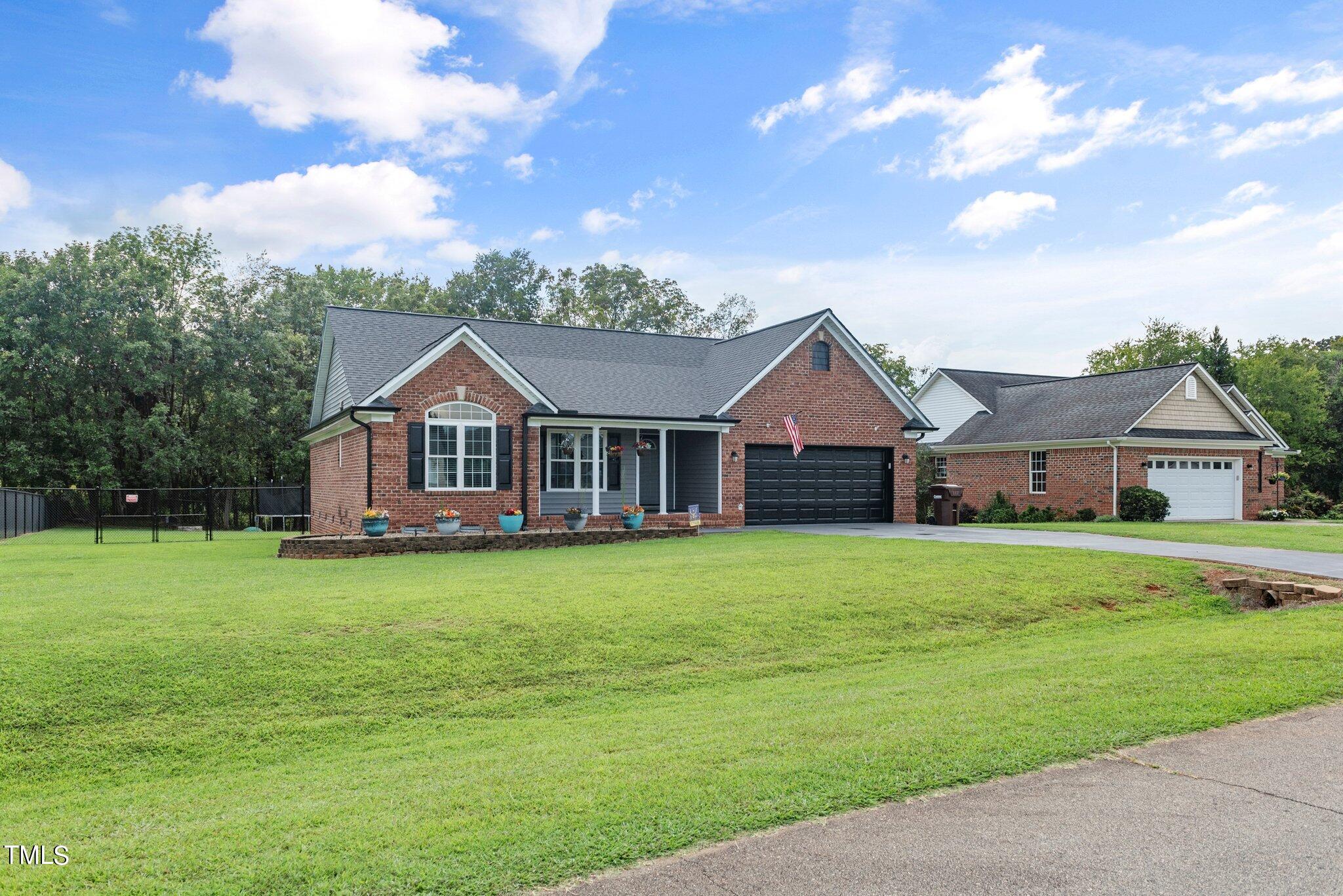2461 Farrell Road Mebane, NC 27302 - Photo 31 of 35 a front view of a house with garden