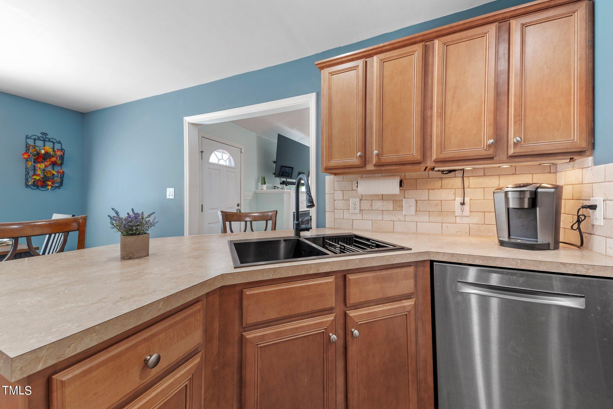 2461 Farrell Road Mebane, NC 27302 - Photo 10 of 35 a kitchen with stainless steel appliances granite countertop a sink a refrigerator and cabinets