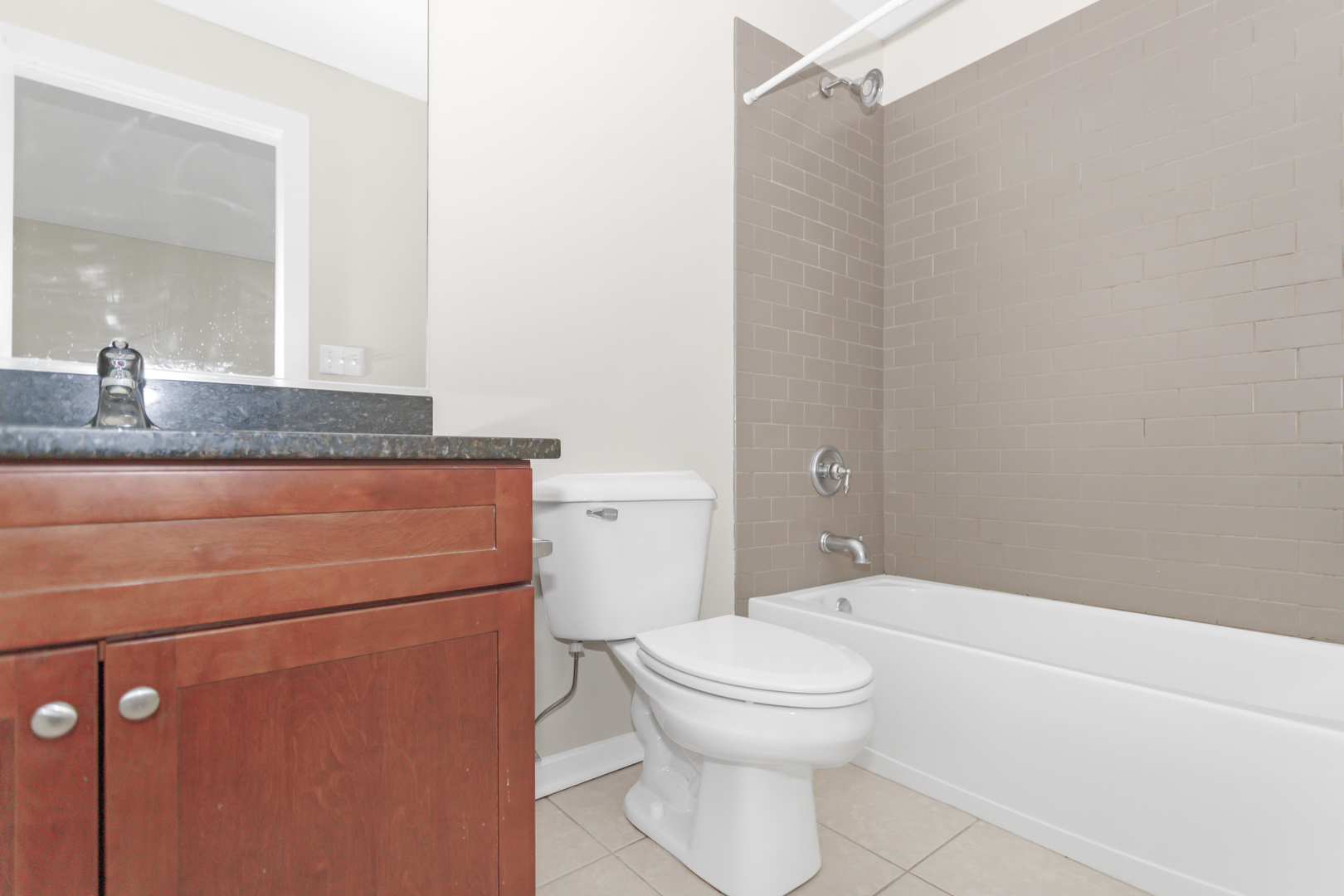 1333 West Taylor Street, Unit 2 Chicago, IL 60607 - Photo 16 of 22 a bathroom with a granite countertop sink toilet and shower