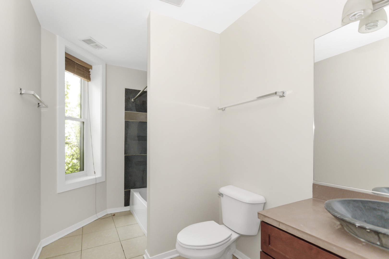 1333 West Taylor Street, Unit 2 Chicago, IL 60607 - Photo 18 of 22 a white toilet sitting next to a bathroom sink