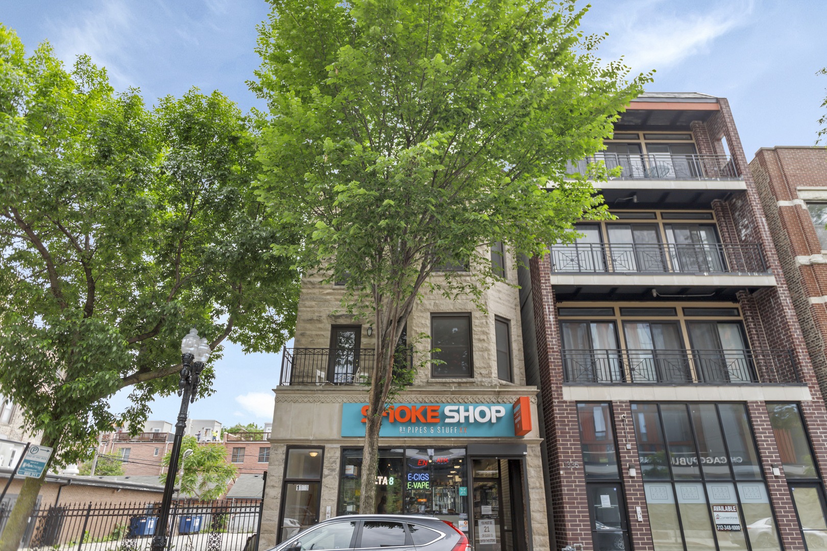 1333 West Taylor Street, Unit 2 Chicago, IL 60607 - Photo 20 of 22 a front view of a residential apartment building with a tree