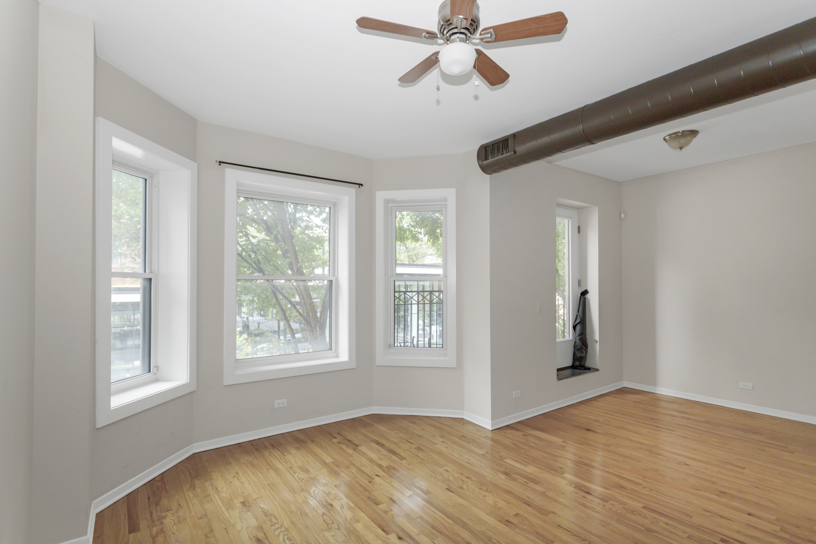 1333 West Taylor Street, Unit 2 Chicago, IL 60607 - Photo 4 of 22 a view of empty room with wooden floor and fan