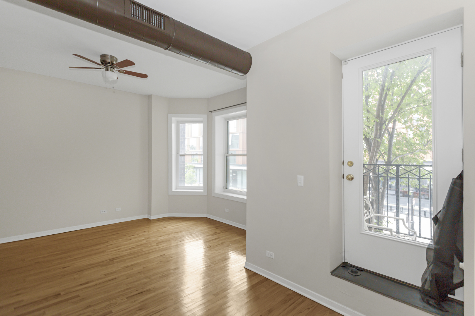 1333 West Taylor Street, Unit 2 Chicago, IL 60607 - Photo 5 of 22 a view of an empty room with wooden floor and a window