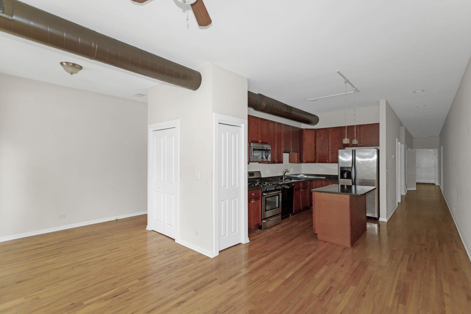 1333 West Taylor Street, Unit 2 Chicago, IL 60607 - Photo 6 of 22 a kitchen with stainless steel appliances granite countertop a refrigerator a stove and a wooden floors