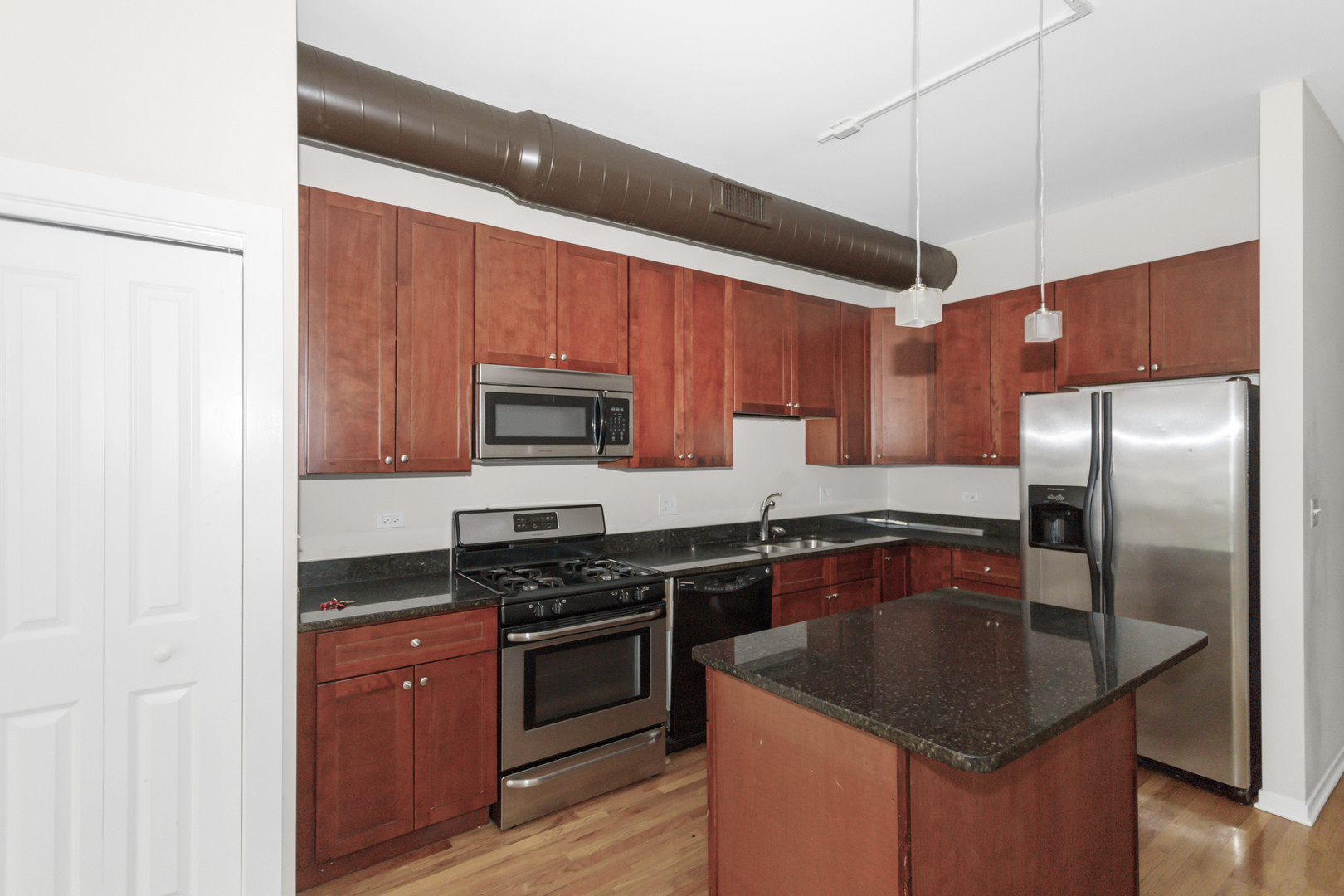 1333 West Taylor Street, Unit 2 Chicago, IL 60607 - Photo 8 of 22 a kitchen with stainless steel appliances granite countertop a sink a stove a refrigerator a washer dryer and a refrigerator