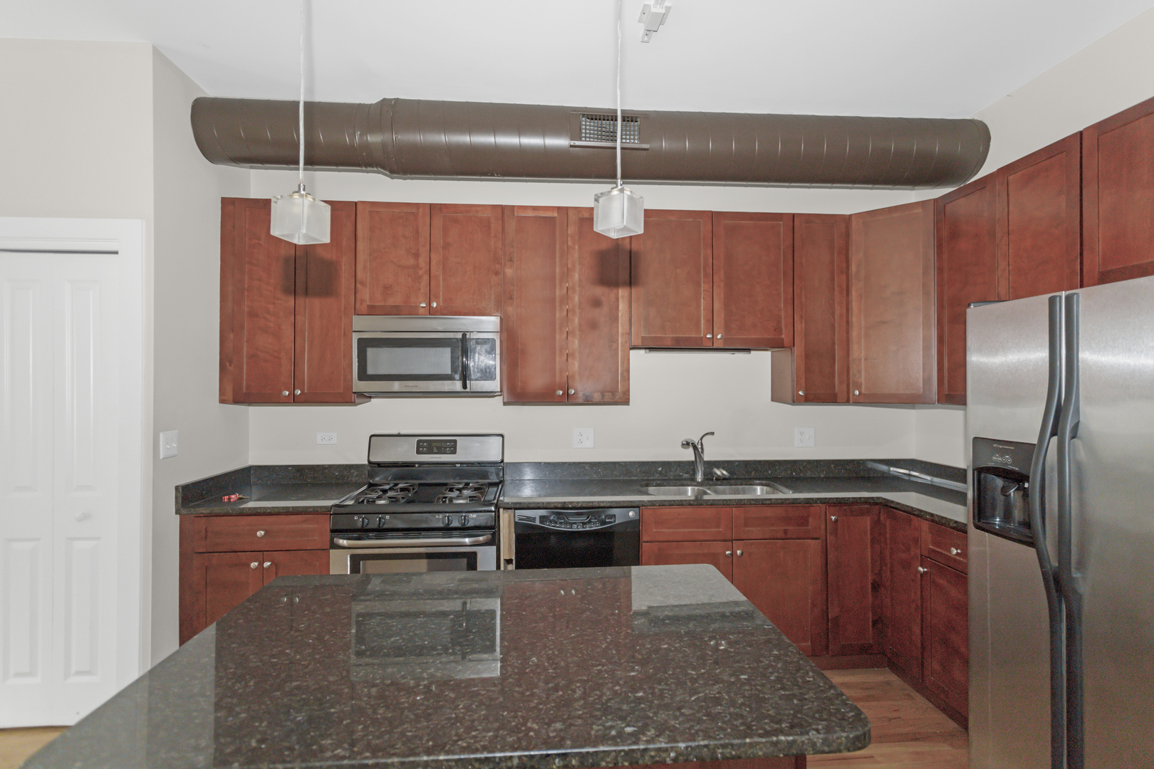 1333 West Taylor Street, Unit 2 Chicago, IL 60607 - Photo 9 of 22 a kitchen with stainless steel appliances granite countertop a sink a stove and a refrigerator