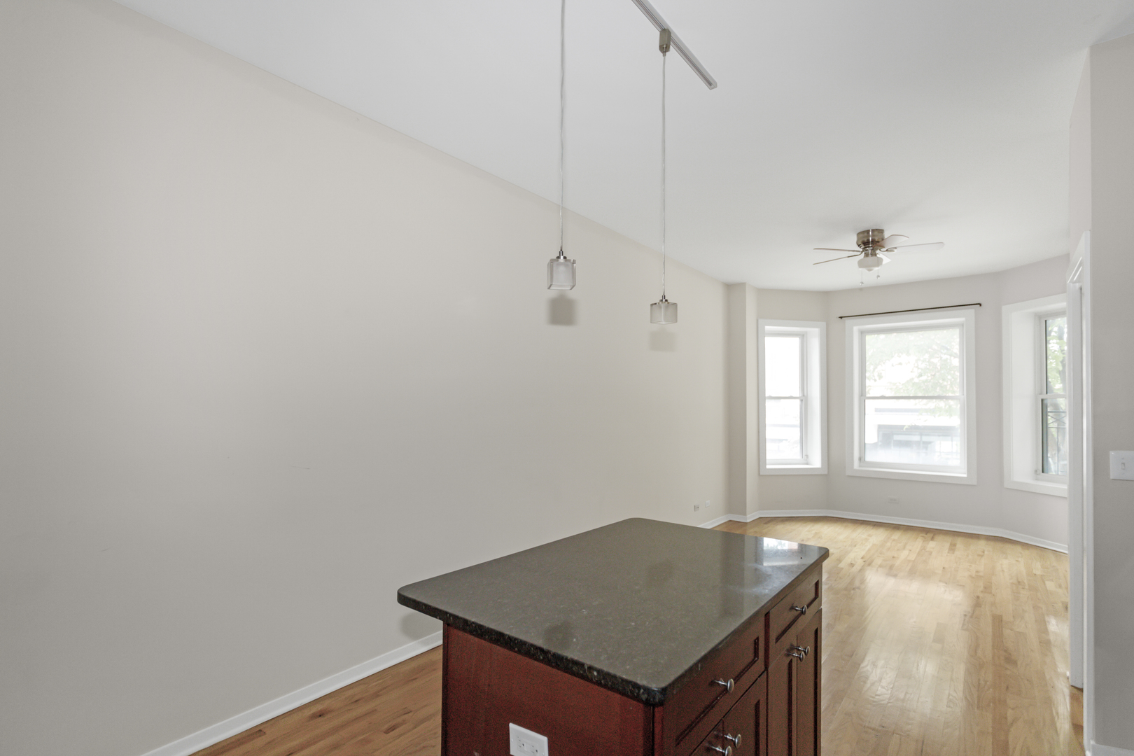 1333 West Taylor Street, Unit 2 Chicago, IL 60607 - Photo 10 of 22 a room with a desk and chandelier fan