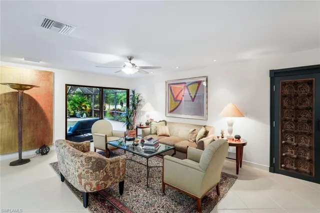 a living room with furniture a lamp and a window