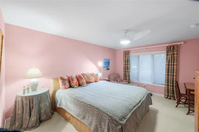 a bedroom with a bed and a lamp