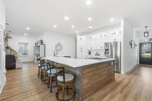 a kitchen with a sink stove and refrigerator